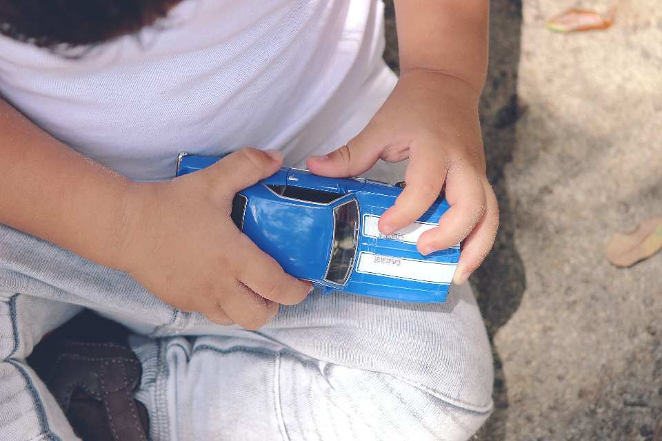 Child Holding Toy Car